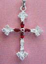 Celtic art craft wholesaler online manufacturers presenting Botonee garnet cross pendant. Sterling silver cross with genuine semiprecious gemstone, shown in garnet. This beautiful pendant skillfully weaves the famous Botonee design into a distinctive and unusal cross centered on a high-quality garnet and cz stone.